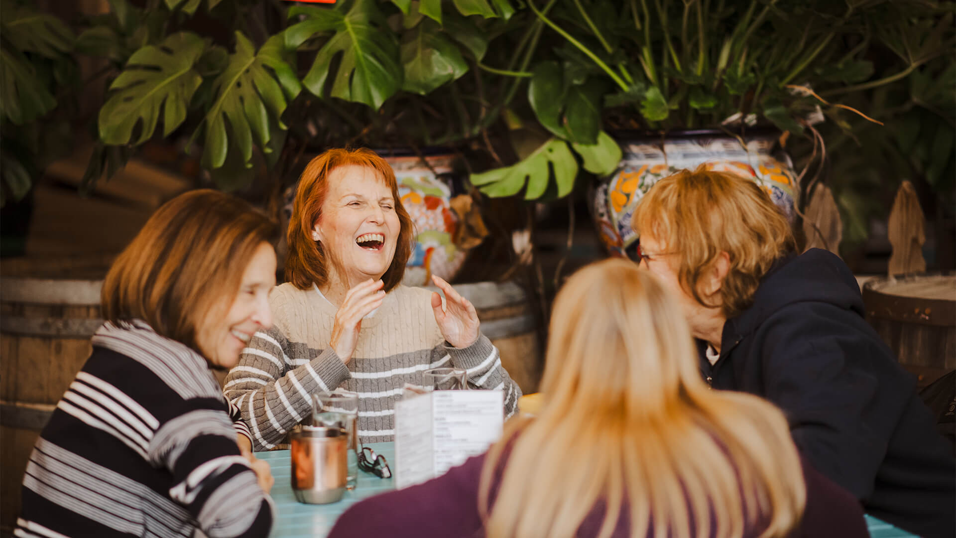 Man in library browsing shelves and holding books