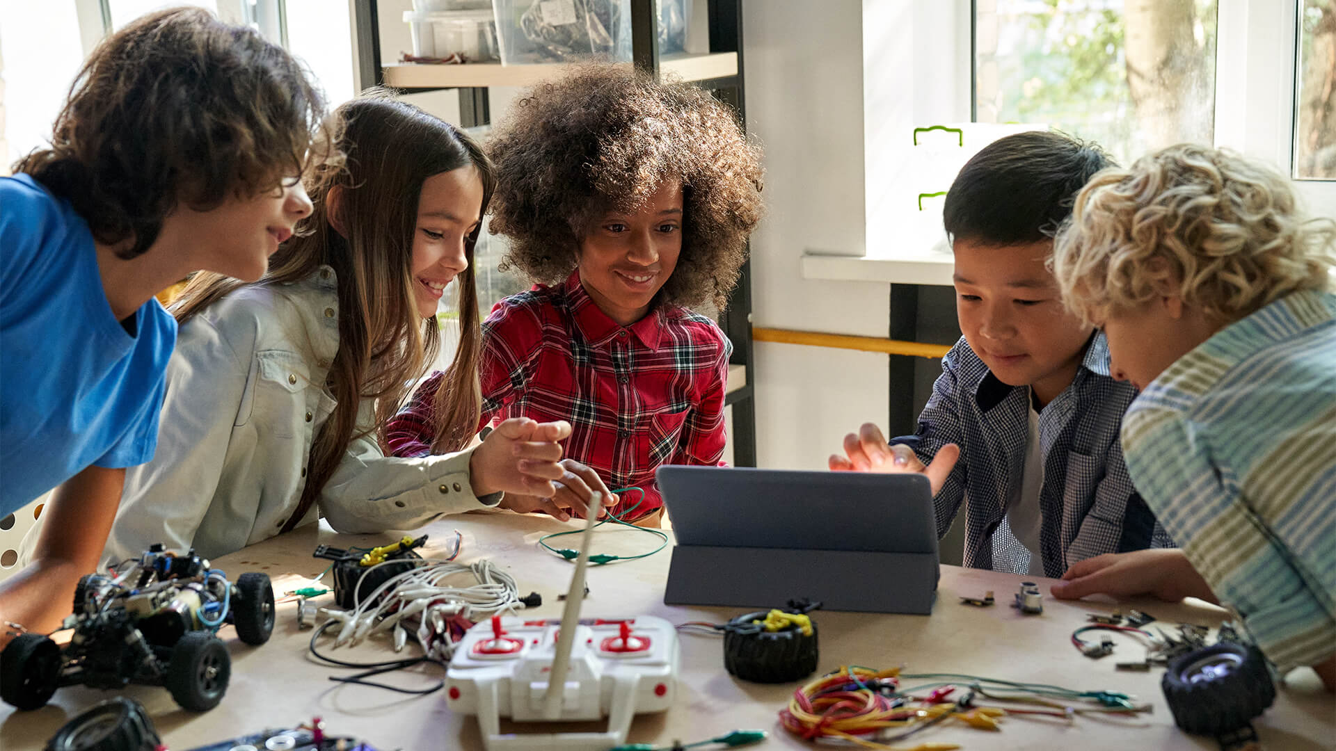 Group of kids playing with robotics