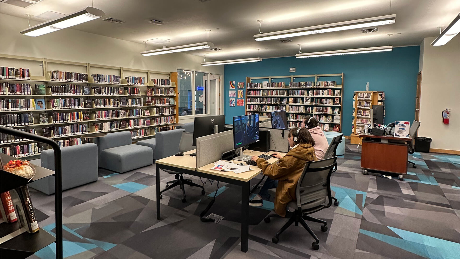 People on computers in a library
